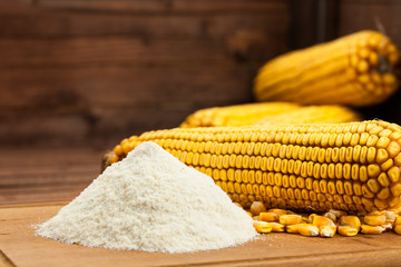 Fototapeta na wymiar Domestic corn flour arranged with corn cob