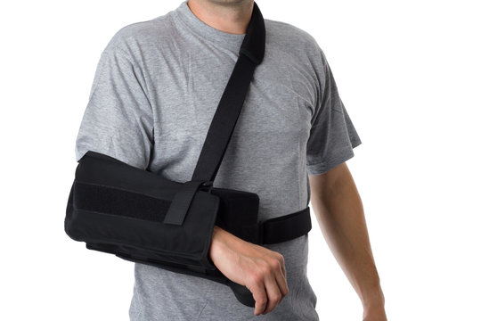Man wearing an arm brace over white