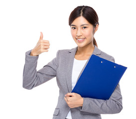 Businesswoman with clipboard and thumb up