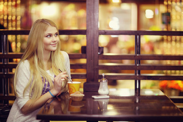 The beautiful blonde in a cafe, holiday diet