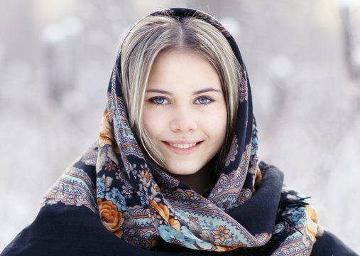 Beautiful Russian woman in a scarf in winter