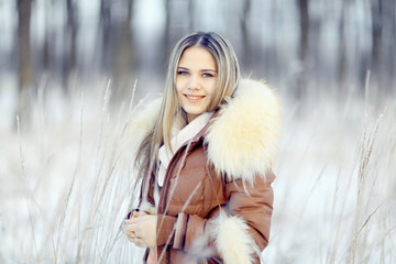 young woman in winter jacket with fur hood