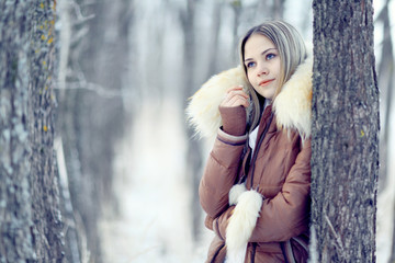 young woman in winter jacket with fur hood
