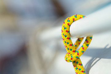 Closeup of yellow thin short rope used for yachting