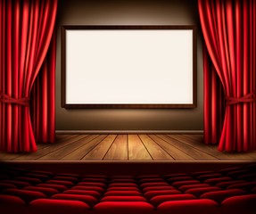 A theater stage with a red curtain, seats and a project board. V