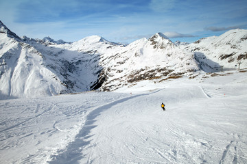 Fototapeta na wymiar The man skiing on snowy slope in Alps, Sportgastein