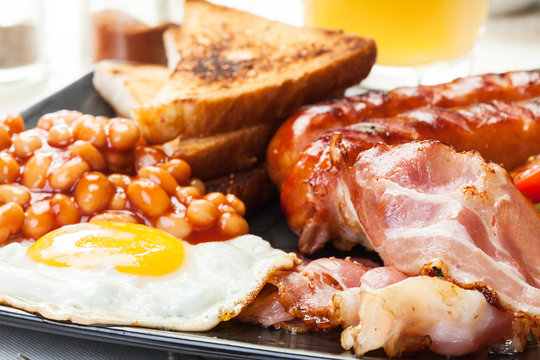 Full English breakfast with bacon, sausage, egg and beans