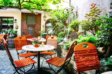 Gartenposter Cafe terrace in small European city © Grecaud Paul