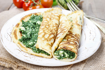 Mediterranean cuisine: crepes stuffed with cheese and spinach