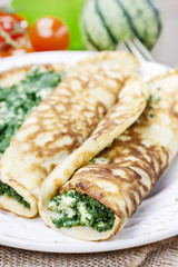Mediterranean cuisine: crepes stuffed with cheese and spinach