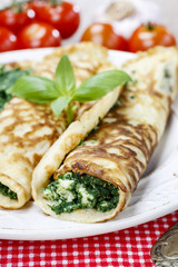Mediterranean cuisine: crepes stuffed with cheese and spinach