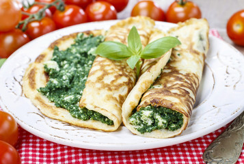 Mediterranean cuisine: crepes stuffed with cheese and spinach