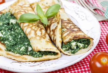 Mediterranean cuisine: crepes stuffed with cheese and spinach