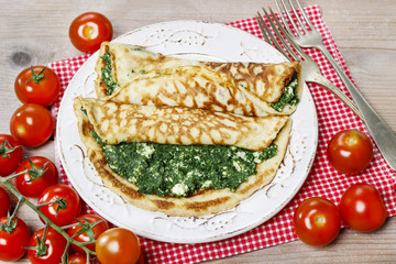 Mediterranean cuisine: crepes stuffed with cheese and spinach