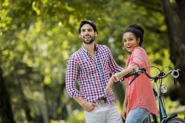 Young couple riding on the tandem bicycle