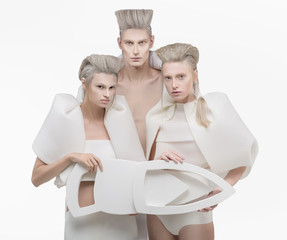 Three persons in white outfit over white background