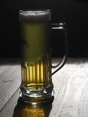 beer on wooden table backlit