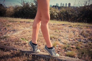 Young woman walking on her tip toes