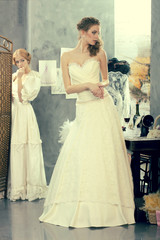 Naklejka premium Bride makes fitting in a vintage design studio