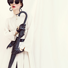 Retro styled fashion girl with umbrella. glamorous portrait