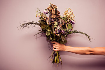 Hand with dead flowers - Powered by Adobe