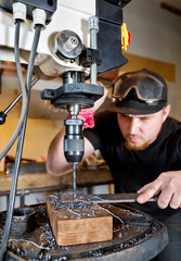 Man in work on electric drill press