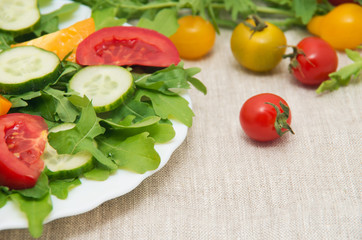 Fresh salad with tomatoes, rucola and cucumbers