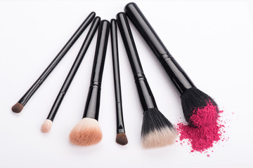 Close-up of  professional  make-up brush with crashed pink eye s