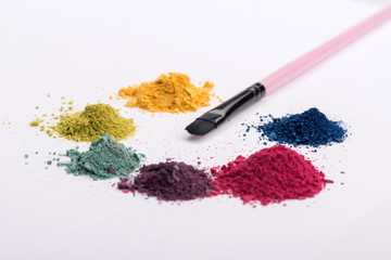 Close-up view of  professional make-up brush surrounded by heaps