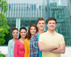 group of smiling teenagers over city background