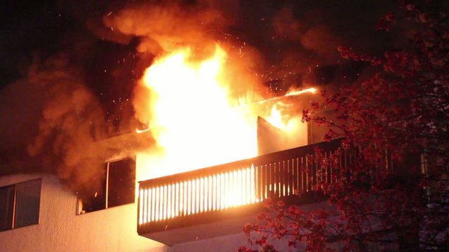 Residential building's balcony fully involved in heavy flames