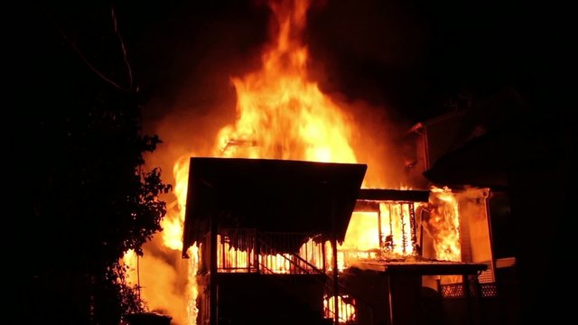 House fire fully involved in flames and spreading to houses