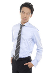 young business man standing with hands in pocket