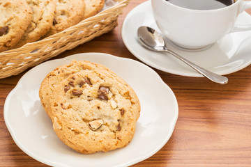 Fototapeta na wymiar Chocolate chip cookie with almond and coffee cup
