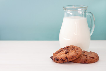 Lemon pound cake sliced Chocolate chip cookies and a jug of milk