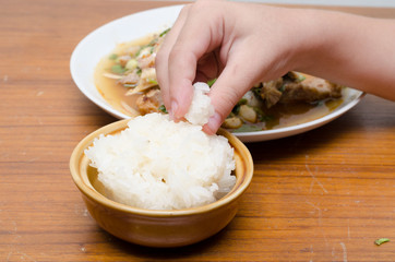Using hand for eat sticky rice