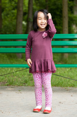 Smiling asian girl in park