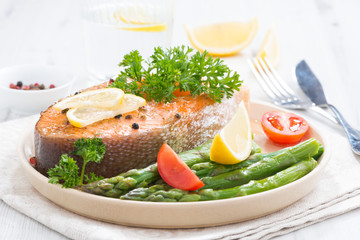 baked salmon with asparagus and lemon on plate