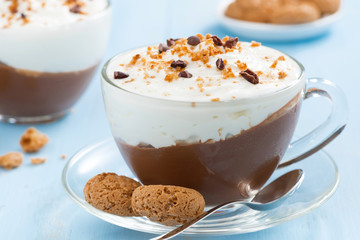 dessert with chocolate, cream and amaretti on a blue background