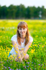 young beautiful woman on  green lawn