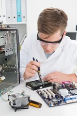 Young technician working on broken computer