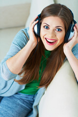 Smiling woman listening music in headphones.