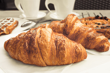 coffee and croissants on table