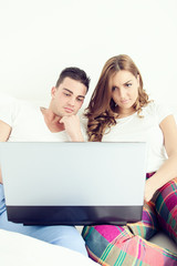 casual young couple enjoying using laptop