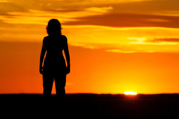 Silhouette of a woman at sunset