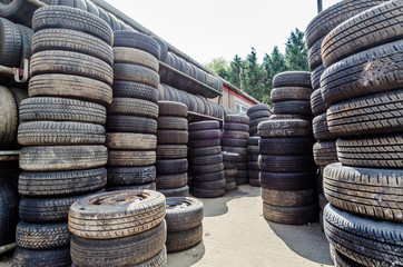 Stacks of old car tyres at  scrapyard