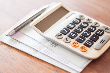 Calculator and pen with bank account passbook