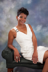 black woman sitting and smiling at the camera