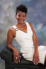 black woman sitting and smiling at the camera