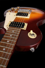 Sunburst electric guitar on black background